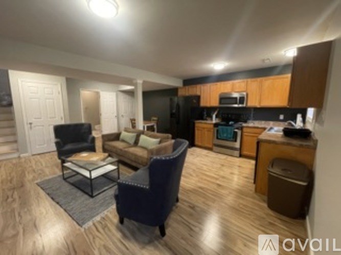 A living room with a couch, chair, and coffee table.