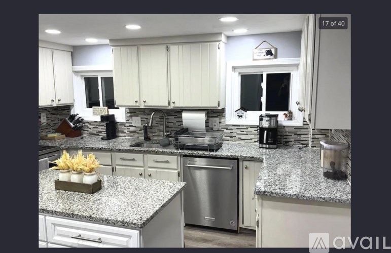 A kitchen with granite countertops and stainless steel appliances.