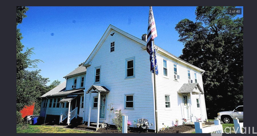 A white house with a flag on the front.