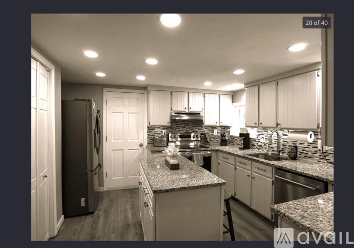 A kitchen with granite countertops and stainless steel appliances.