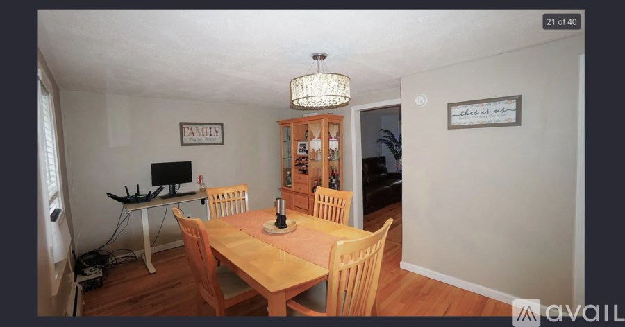 A dining room with a wooden table and chairs.