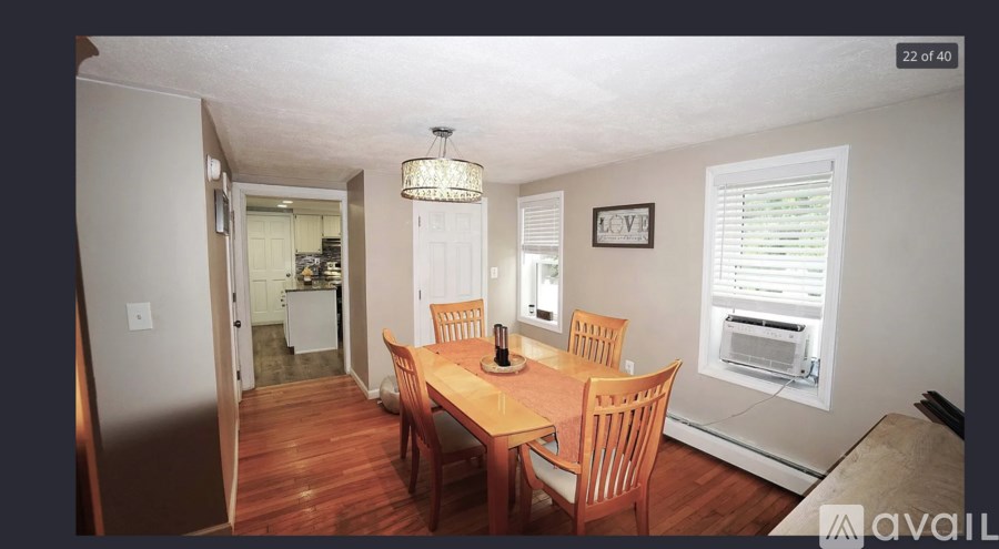 A dining room with a wooden table and chairs.