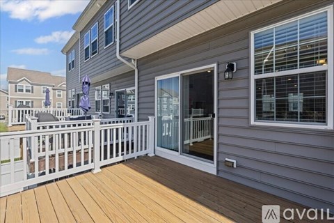 A house with a deck and a sliding glass door.