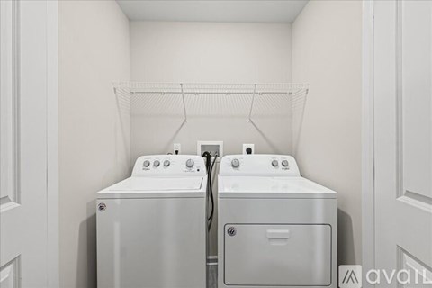 A small laundry room with a washer and dryer.