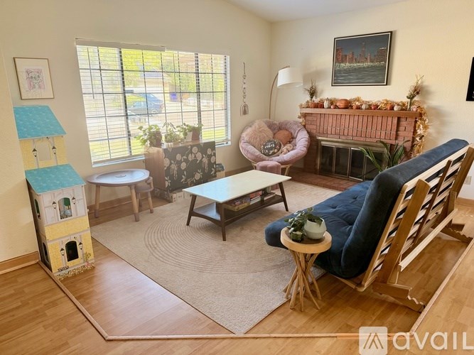 A living room with a fireplace and a chair.