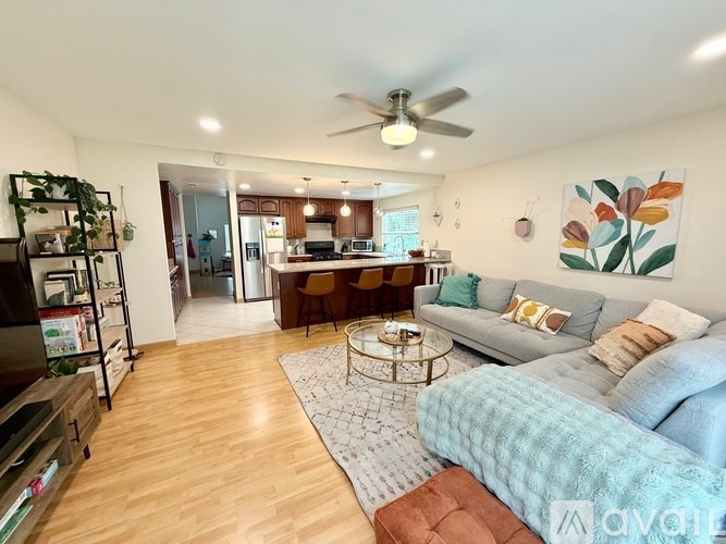 A living room with a grey couch and a coffee table.