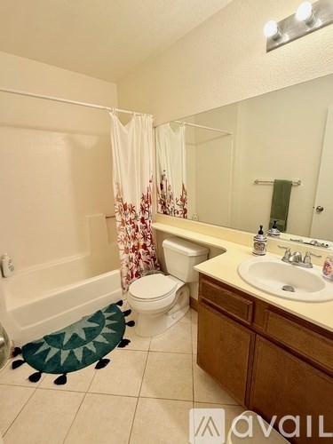 A bathroom with a toilet, sink, and shower.