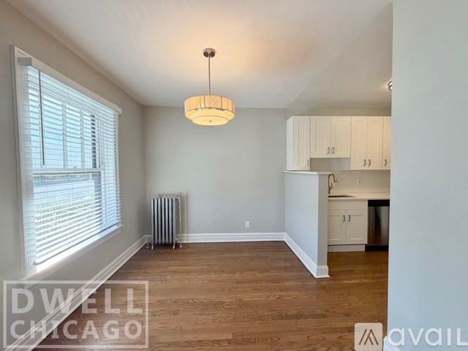 A room with a wooden floor and a ceiling light.