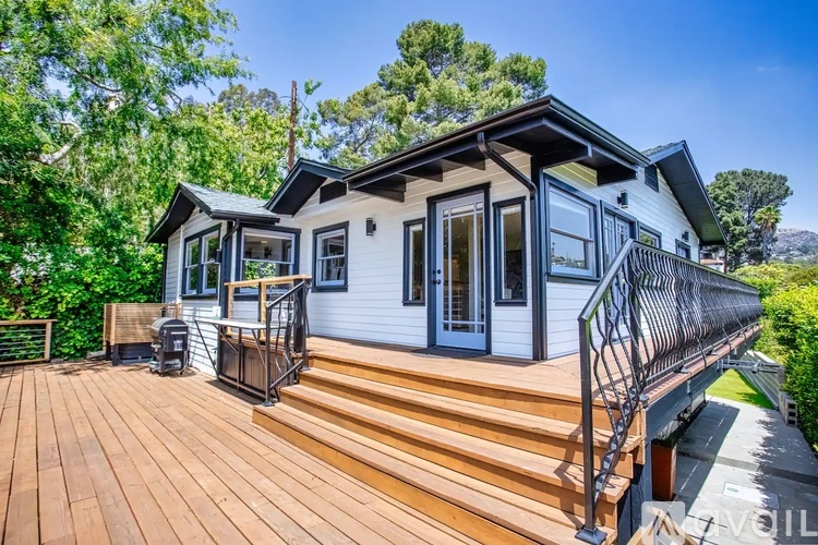 A house with a deck and a metal railing.