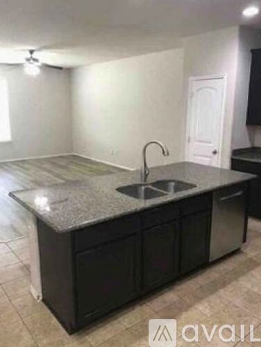 A kitchen with a sink and cabinets.