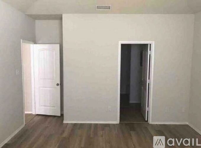 A room with a door on the left and another door on the right.
