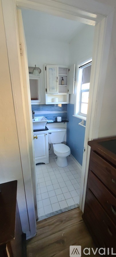 A bathroom with a toilet and a sink.