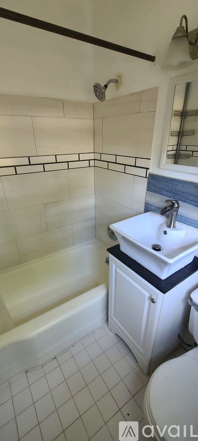 A white bathroom with a black and white counter.