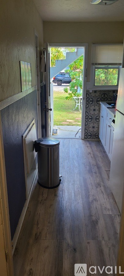 A long hallway with a trash can in the middle.