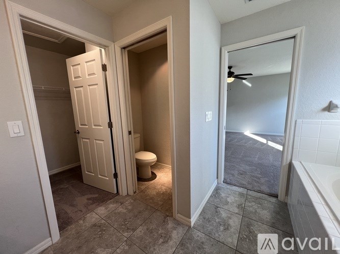 A bathroom with a toilet and a bathtub.