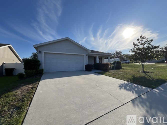 A house with a white garage door is for sale.
