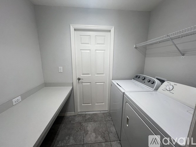 A small laundry room with a washer and dryer.