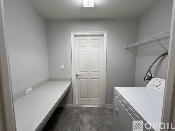 A small laundry room with a washer and dryer.