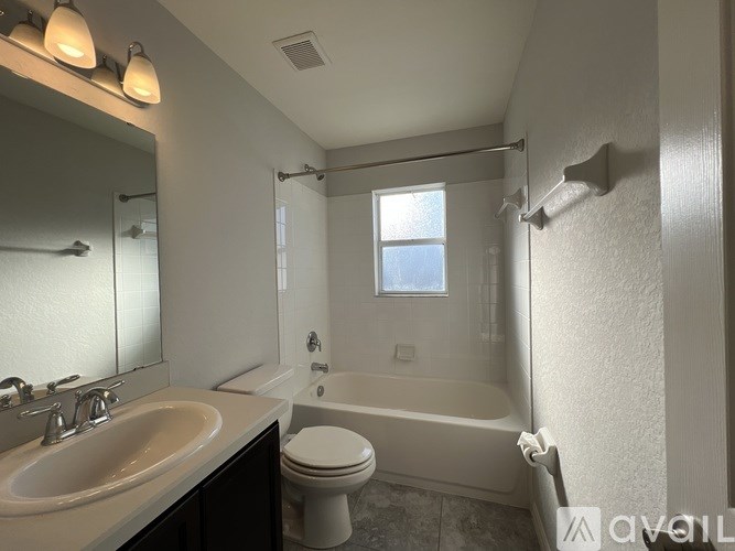 A white toilet sits next to a sink in a bathroom.