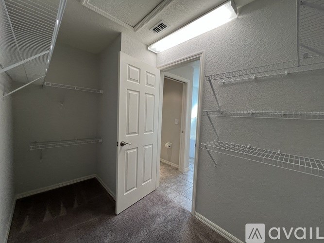 A small, empty room with a door and a window.