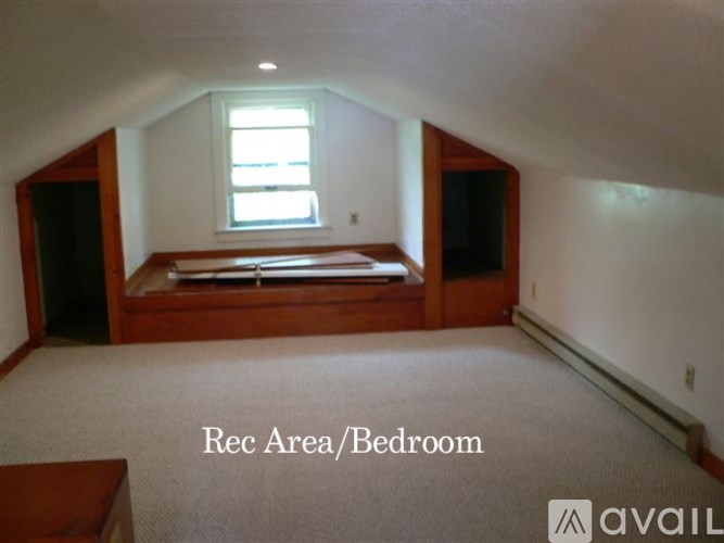 A bedroom with a bed and a window.
