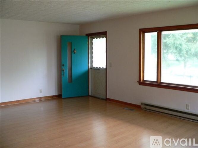 A room with a blue door and a window.