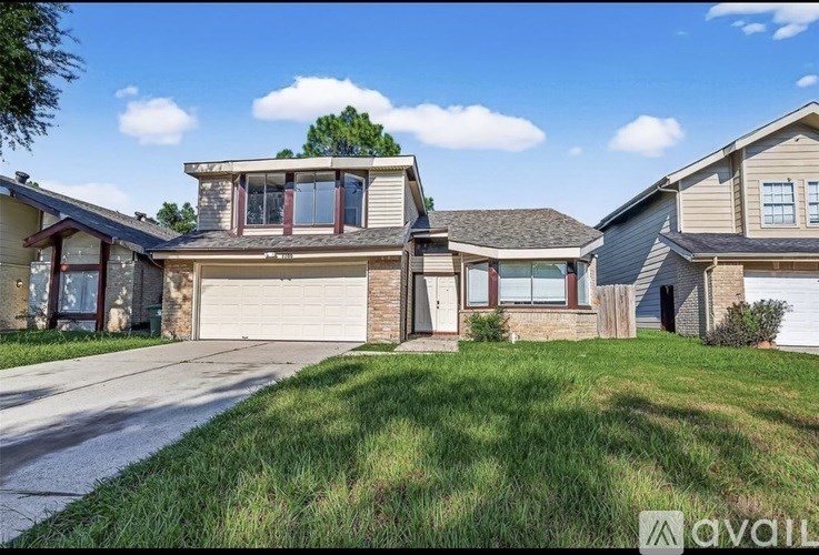 A house with a garage is for sale.