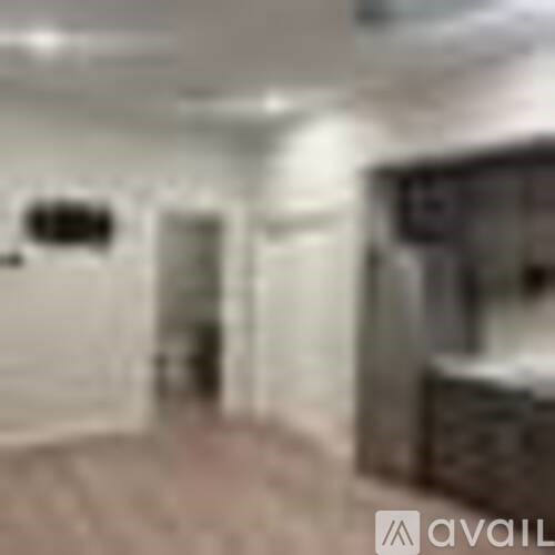 A blurry image of a room with a bed and a window.