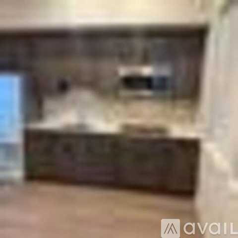 A blurry image of a kitchen with a counter and a sink.