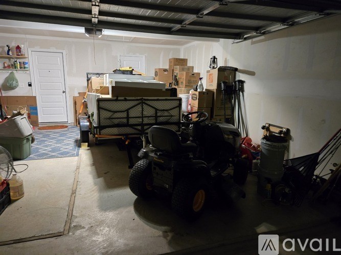 A room with a forklift and boxes on the floor.