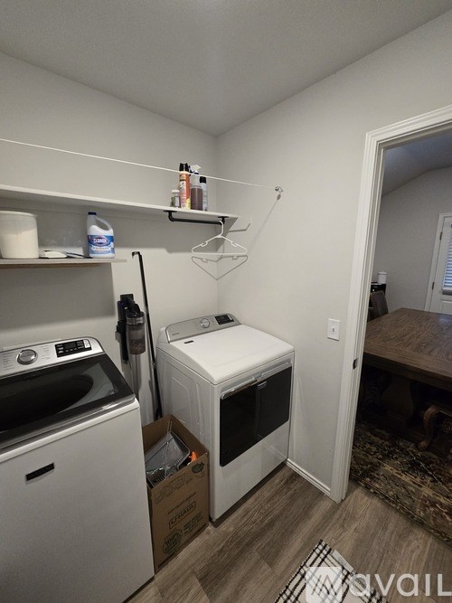 A small laundry room with a washer and dryer.