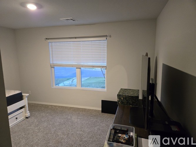 A room with a window overlooking a beach.