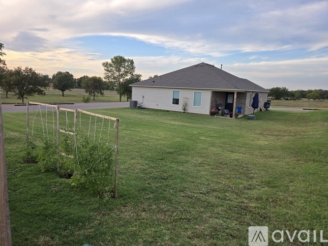 A house with a fenced yard in front of it.