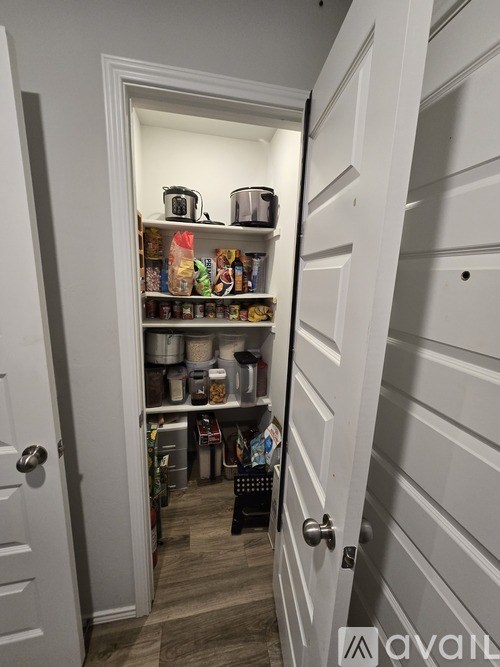 A white door with a handle and a shelf with various items on it.