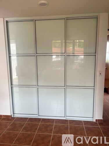 A glass door with a white frame in a room.