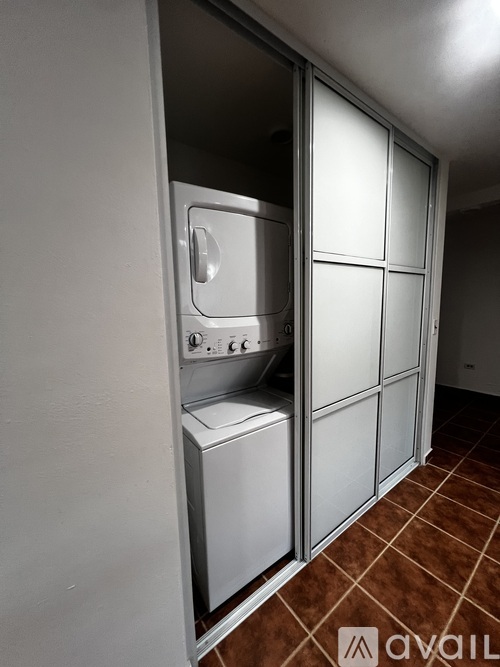 A stainless steel oven with a door open is in a kitchen.