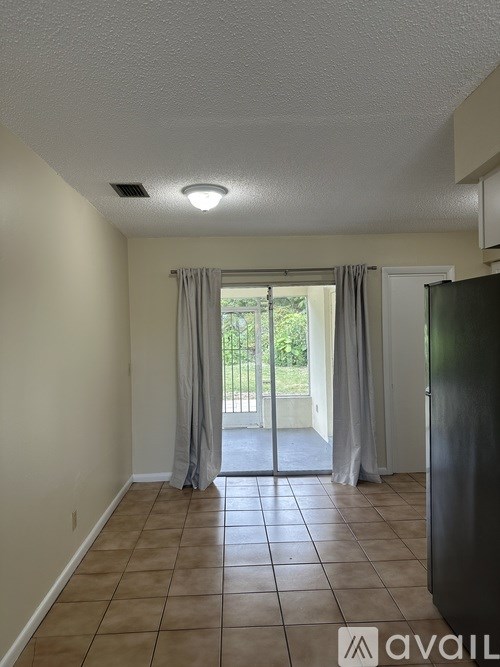 A room with a tiled floor and a sliding glass door.