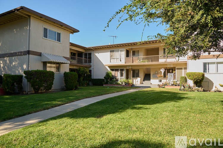 A row of houses with a grassy area in front.