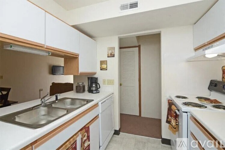 A kitchen with white cabinets and a stove top oven.