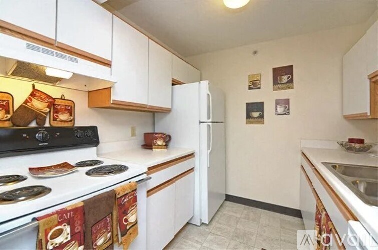 A kitchen with a stove, refrigerator, and oven.