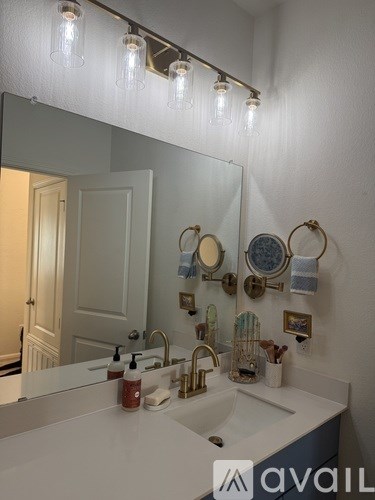 A bathroom with a white sink and a mirror above it.