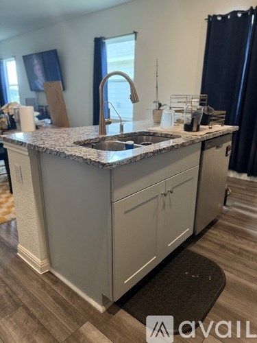 A kitchen with a granite countertop and a sink.