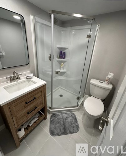 A bathroom with a sink, toilet, and shower.