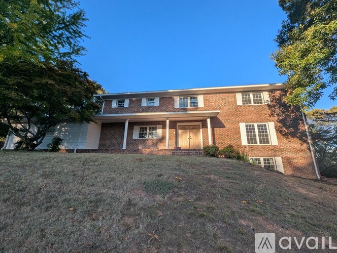 A house with a large front yard is for sale.