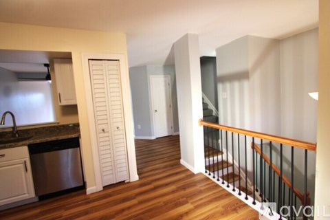 A kitchen with a sink and a refrigerator.
