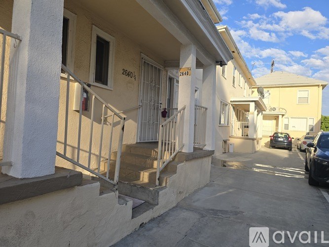 A street view of a residential area with houses numbered 2601 and 2603.