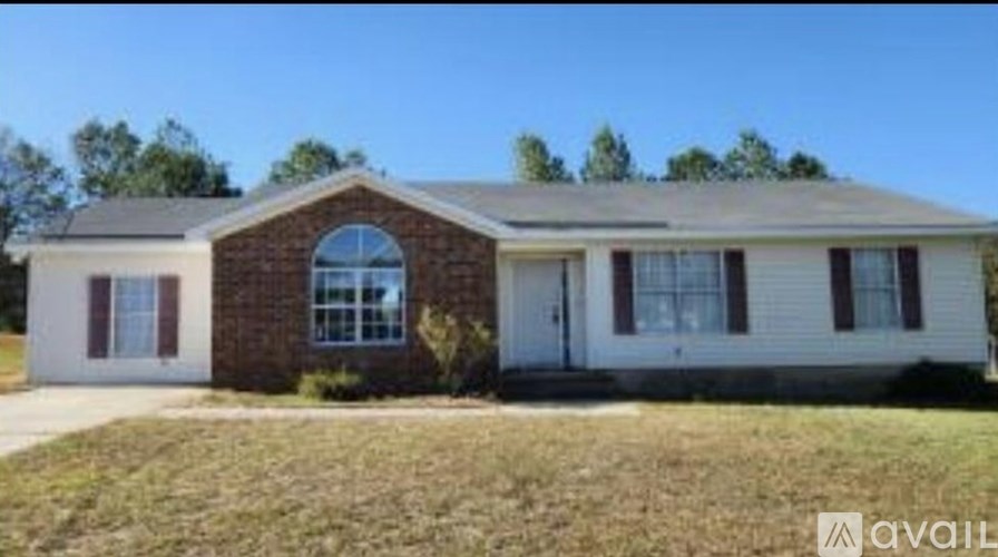 A house with a brown brick front and a white door is available for purchase.