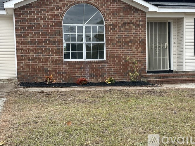 A room with a ceiling fan and a window.