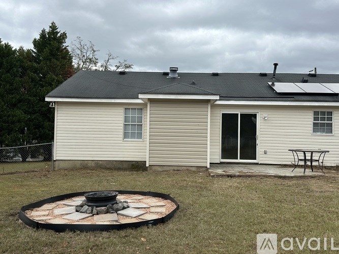 A house with a fire pit in the yard.