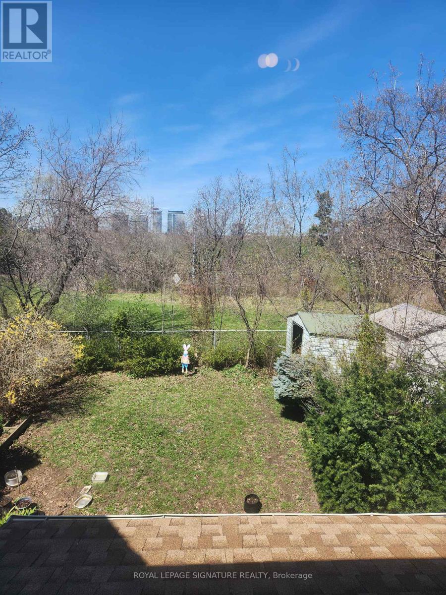 A backyard with a person standing in the middle of it.